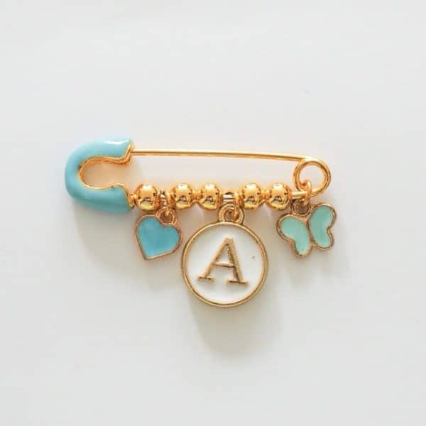 hellblaue Nadel mit 3 charms, gold