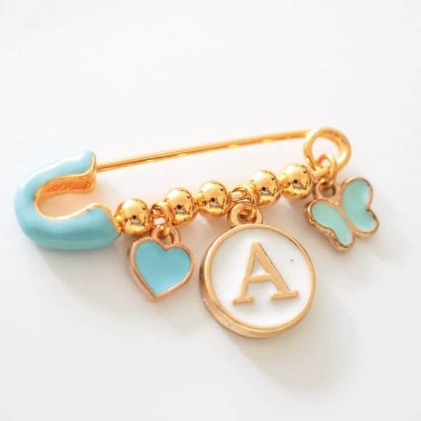 hellblaue Nadel mit 3 charms, gold