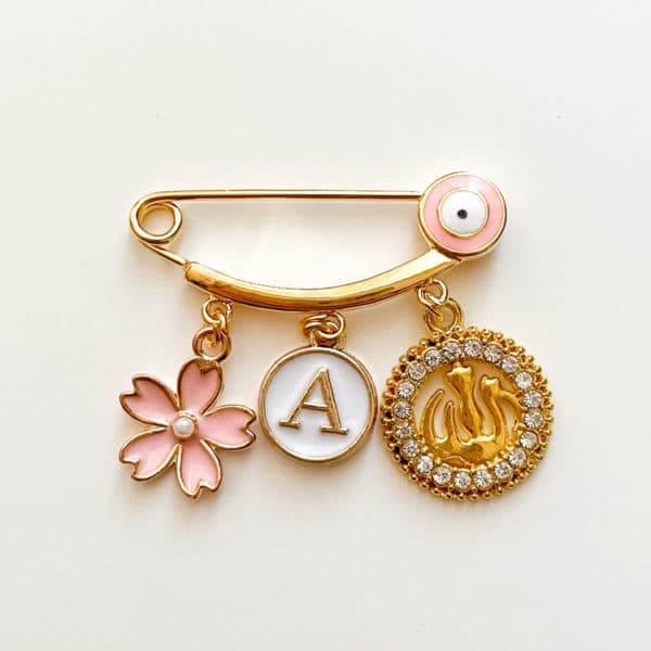 rosa Nadel mit Auge und 3 Charms, gold